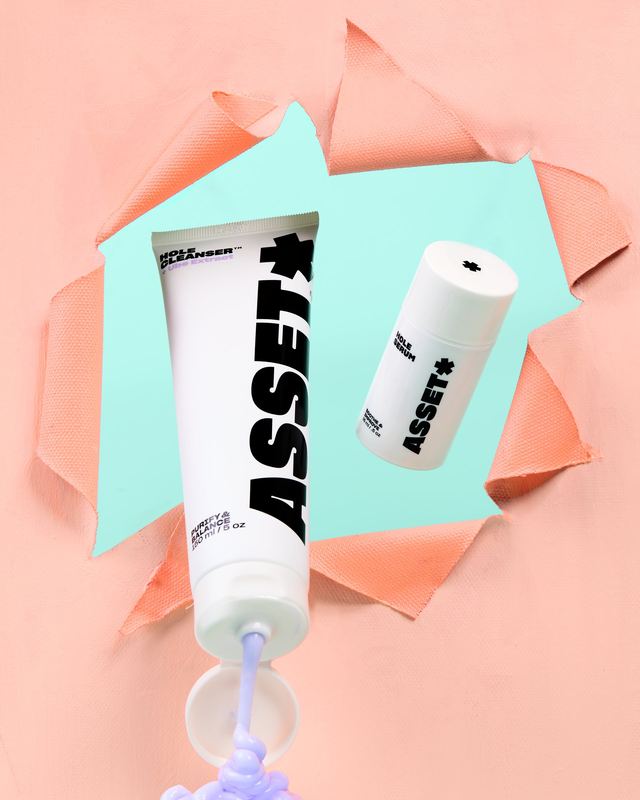 Tube squeezing through torn paper, Asset by David Spector