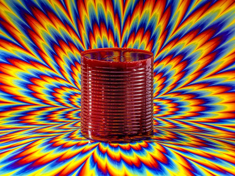 Red tin on a swirling op art ground, Byline Optical Illusions by David Spector