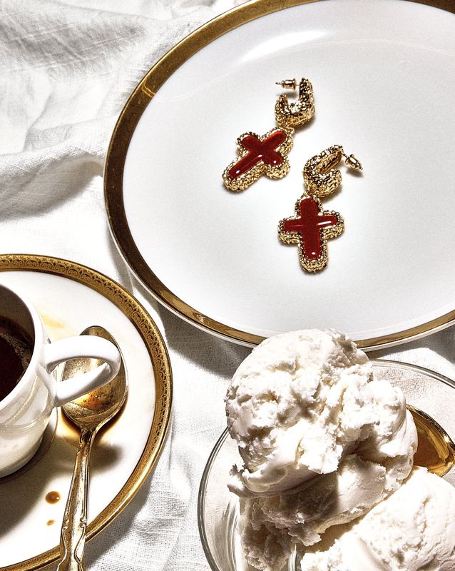 Cross earrings on a dessert plate, Mudpearl by David Spector