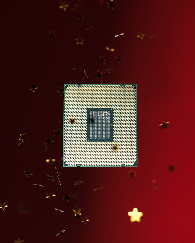 Processor chip in a fall of gold star confetti, Bloomberg by David Spector