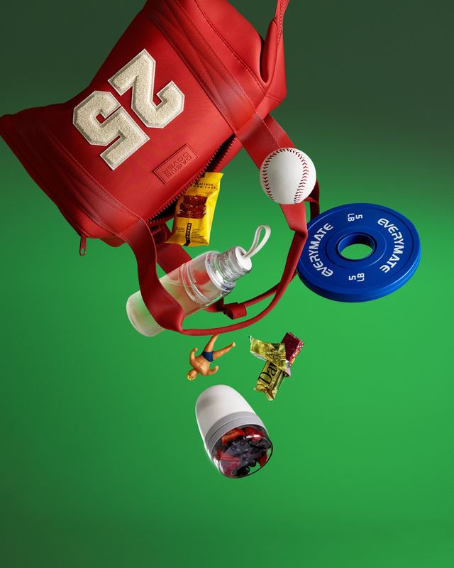 Red gym bag spilling snacks and a weight plate, Bon Appétit by David Spector