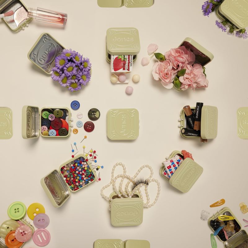 Open tins filled with flowers, buttons and pins, Byline Jones Editorial by David Spector