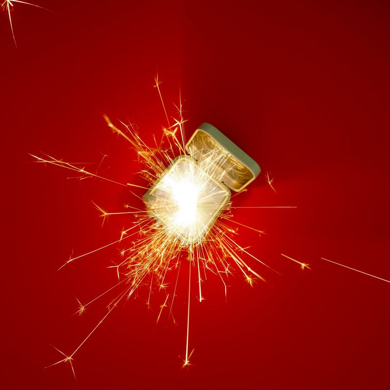 Tin lit by a sparkler on red, Byline Jones Editorial by David Spector