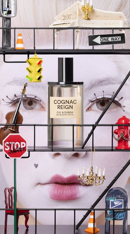 Bottle in a toy street scene over a painted face, Cognac Reign by David Spector