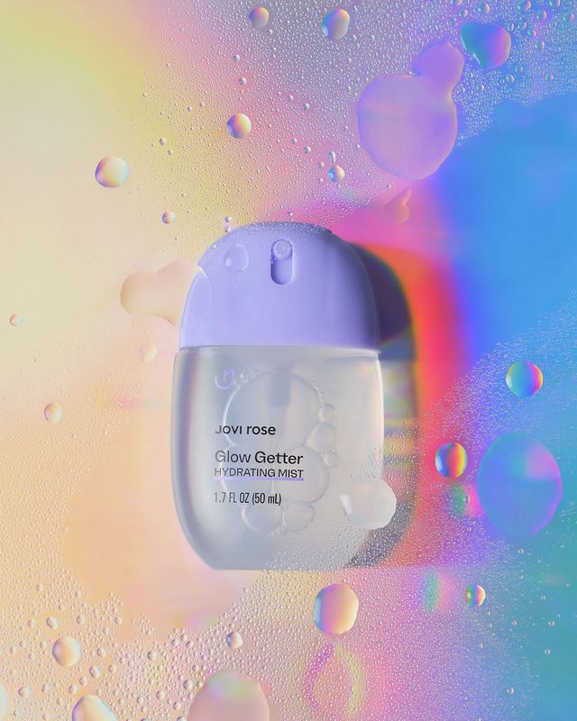 Bottle on iridescent light with droplets, Jovi Rose