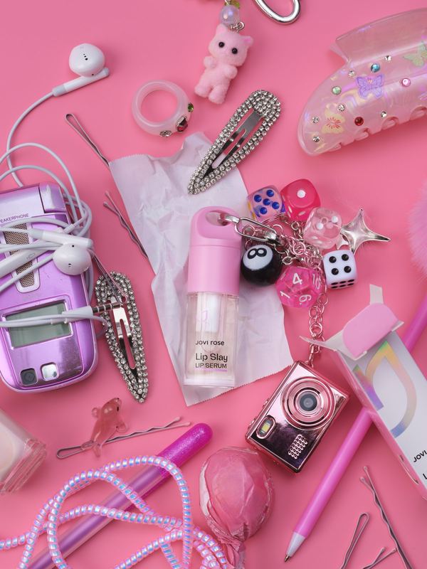 Bottle among pink trinkets, Jovi Rose by David Spector