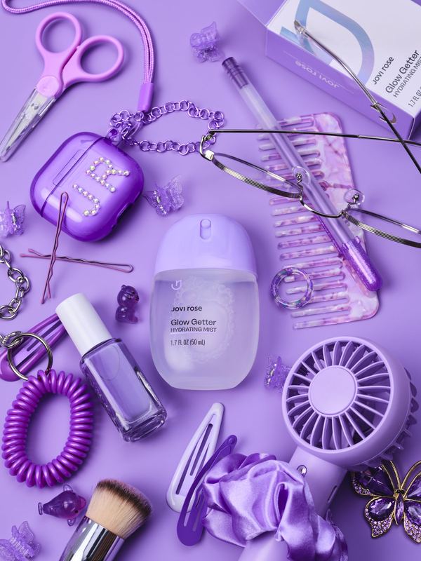 Bottle among purple accessories, Jovi Rose by David Spector