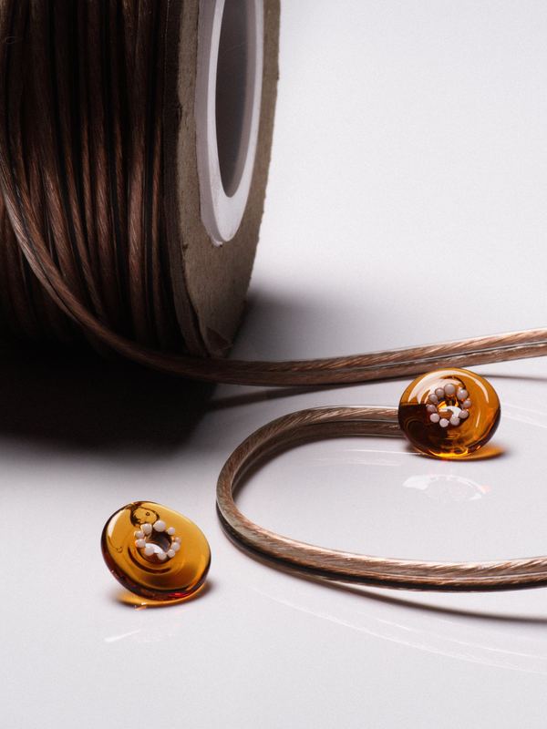 Amber rings with a spool of waxed cord, Keane Art Deco by David Spector