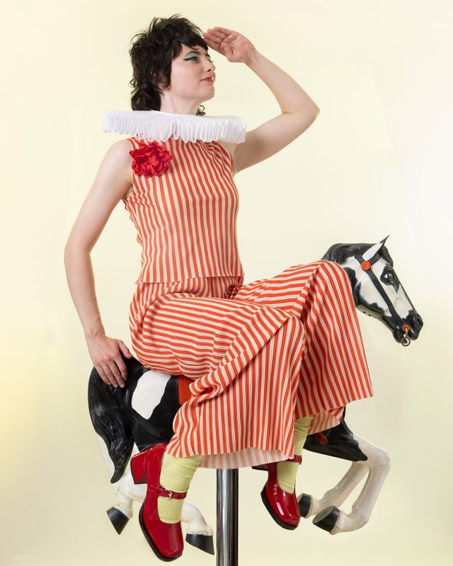 On the carousel horse, full length, Sarah Squirm by David Spector