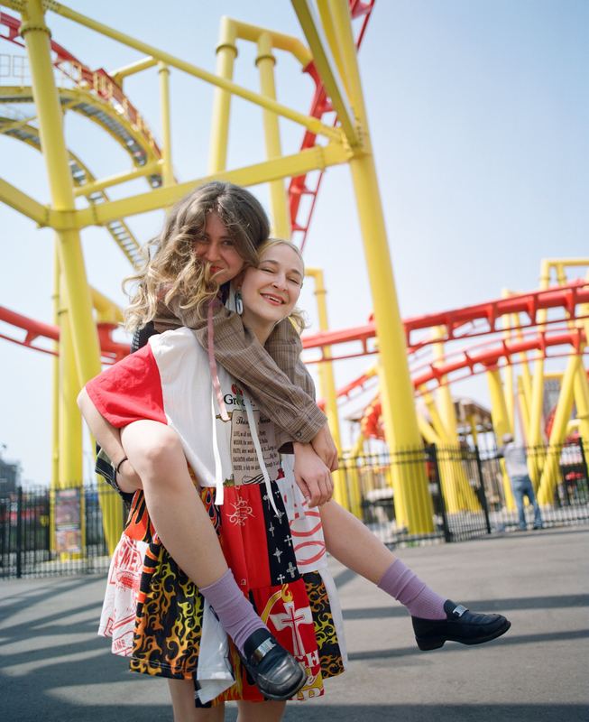 Piggyback ride under a roller coaster, Madeline Cash by David Spector