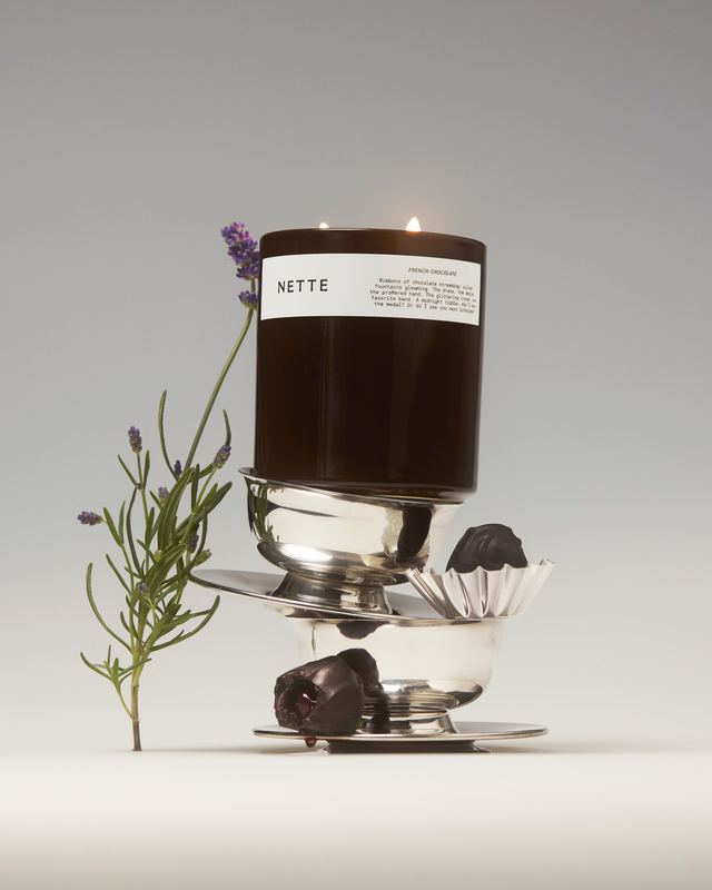 Candle on stacked silverware with lavender, Nette by David Spector