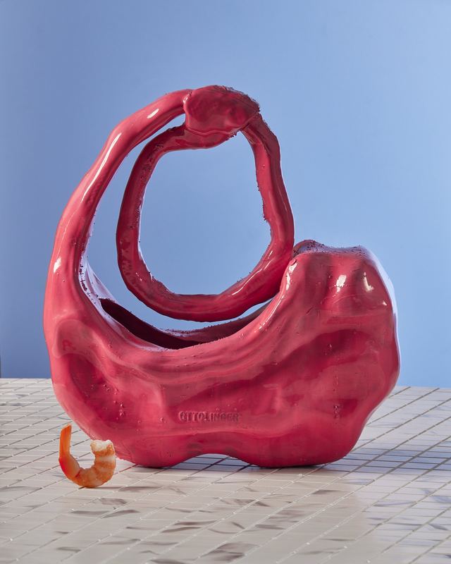Red sculptural bag on marble, Ottolinger by David Spector