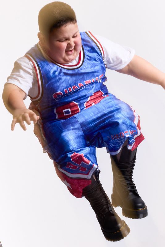 Mid-jump in a blue basketball jersey, Rizzler by David Spector