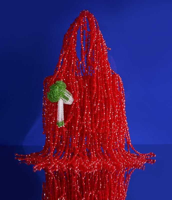 Red beaded bag on blue, Susan Alexandra by David Spector